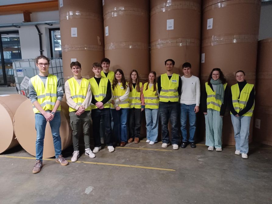 Gruppenbild vor den eindrucksvollen Papierrollen